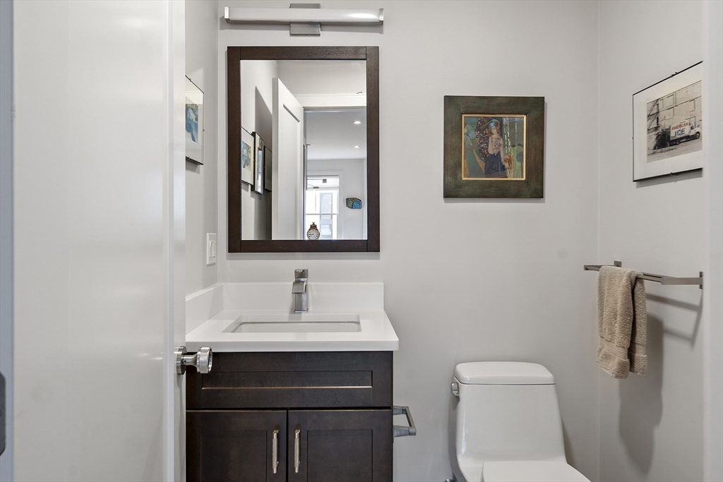 186 Mason Terrace, Unit 186 Brookline, MA 02446 - Photo 20 of 27 a bathroom with a toilet sink and mirror