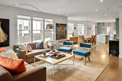 a living room with furniture wooden floor and a flat screen tv