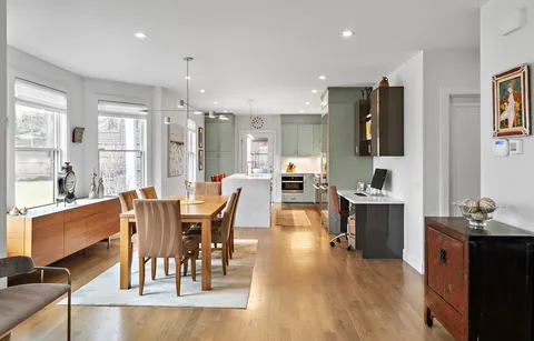 a view of a dining room with furniture window and wooden floor