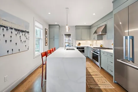a kitchen with stainless steel appliances a refrigerator and a stove top oven