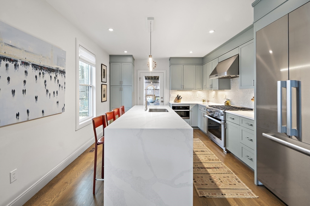 186 Mason Terrace, Unit 186 Brookline, MA 02446 - Photo 7 of 27 a kitchen with stainless steel appliances a refrigerator and a stove top oven