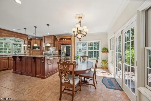 a view of a dining room with furniture large windows and wooden floor