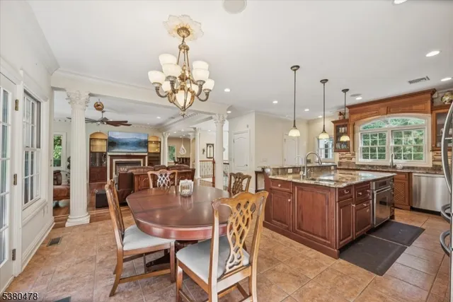 a kitchen with stainless steel appliances granite countertop a stove and a view of dining room