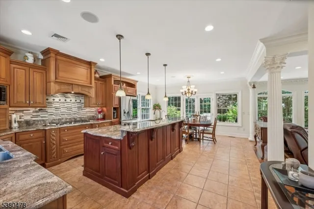 a large kitchen with a large counter top appliances and cabinets