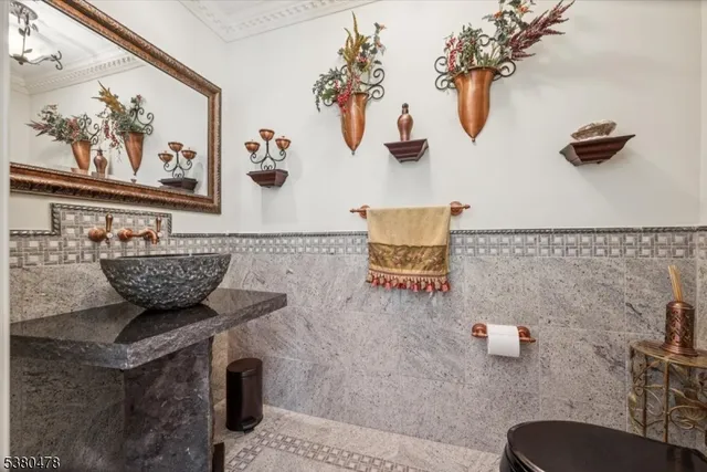 a bedroom with a large bed and a flat tv screen on dresser