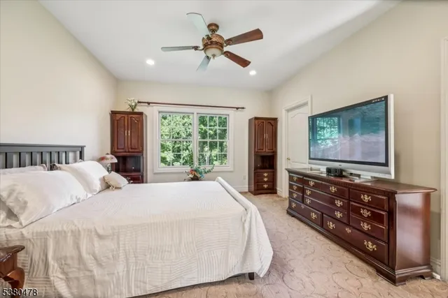a bathroom with a granite countertop sink mirror vanity and toilet