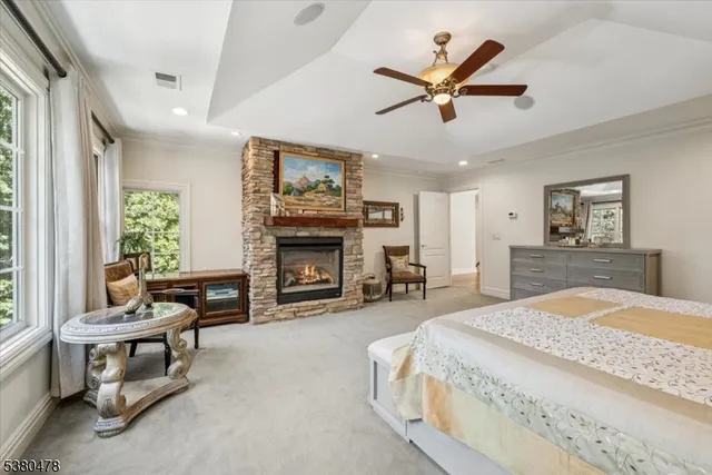 a bed sitting in a spacious bedroom next to a window