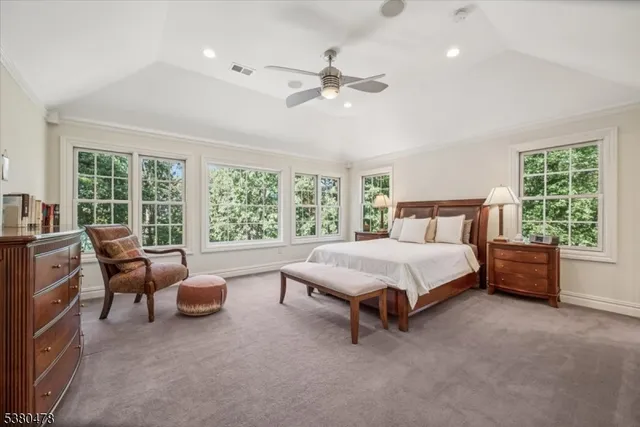 a bedroom with a bed dresser and wooden floor