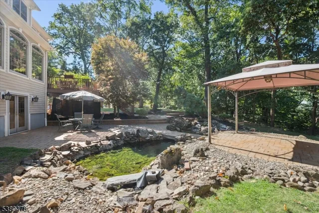 a view of a backyard with table and chairs and potted plants