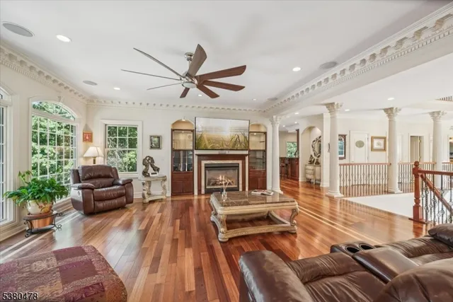 a living room with furniture fireplace and a large window