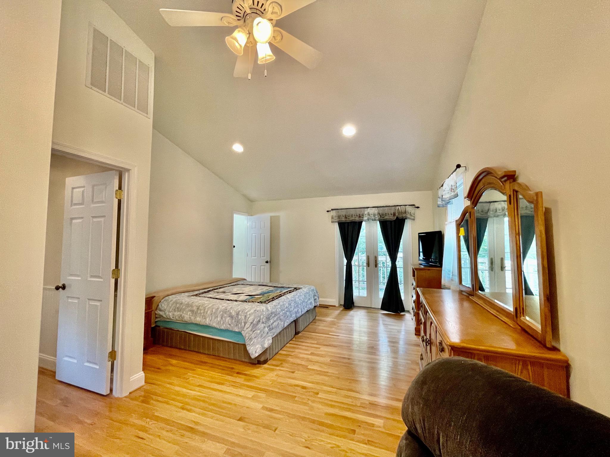 1270 Calvert Beach Road St. Leonard, MD 20685 - Photo 15 of 31 a bedroom with a bed and a mirror