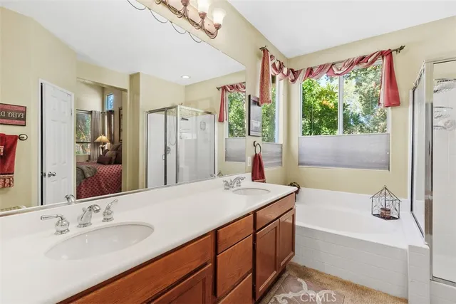 a bathroom with a tub sink and mirror