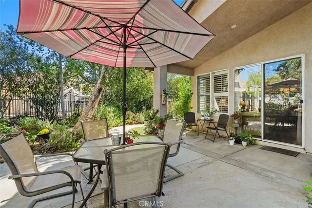 a patio with a patio table and chairs
