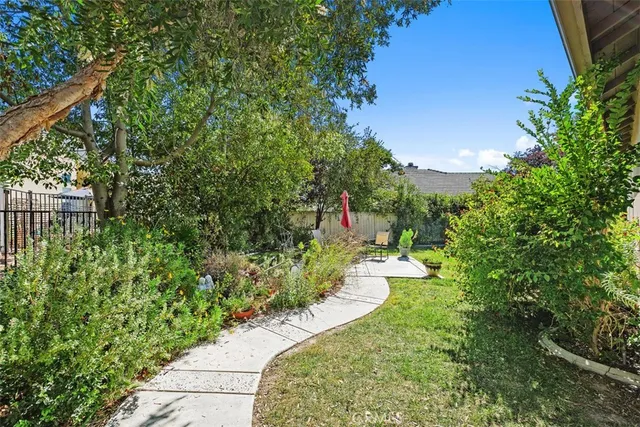 a view of a garden with large trees