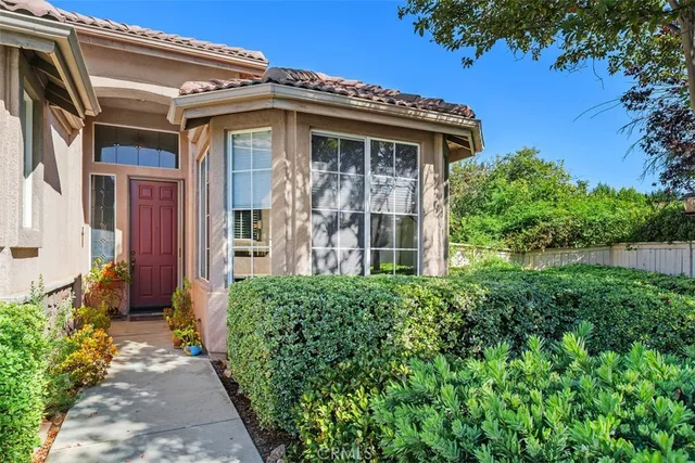 a view of a house with potted plants
