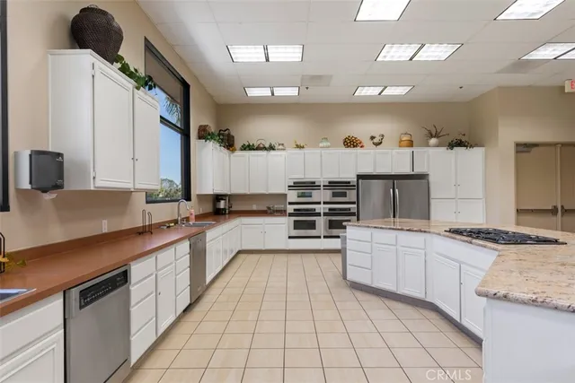 a kitchen with stainless steel appliances granite countertop a sink and cabinets