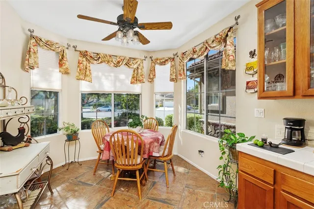 a dining room with furniture a flat screen tv and a large window