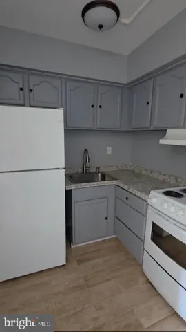 a kitchen with a refrigerator and a sink