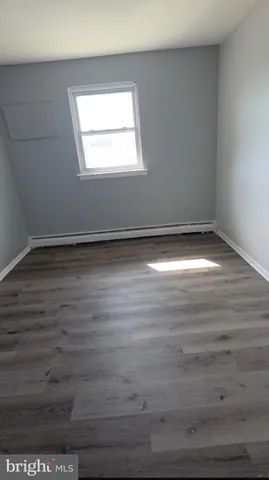 a view of a room with wooden floor and window