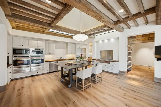 a view of a dining room with furniture wooden floor and a chandelier