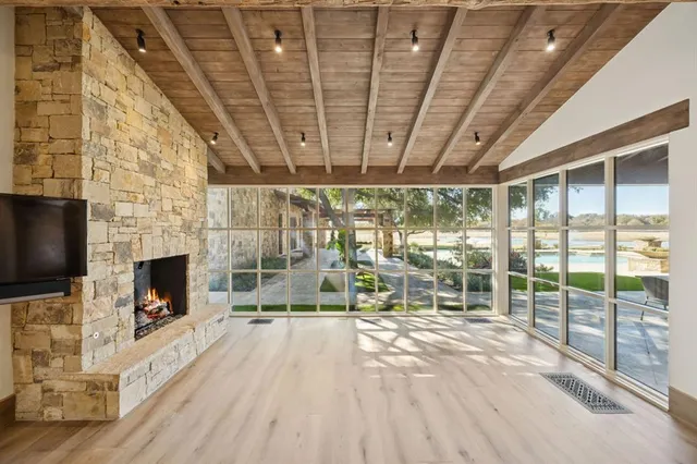 a view of empty room with wooden floor and fireplace