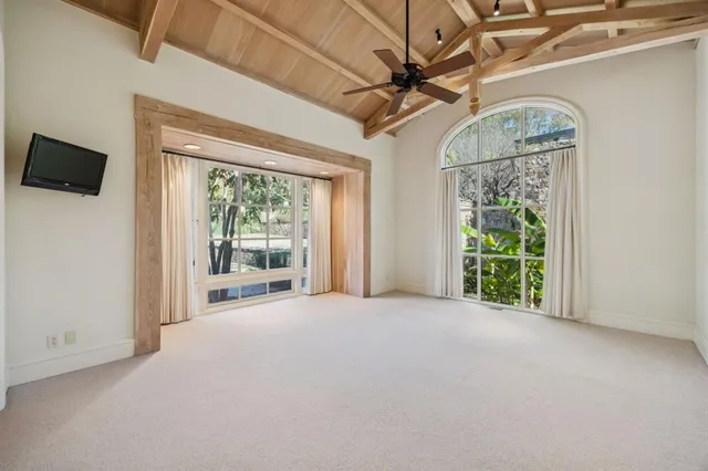 a view of an empty room with a fireplace and a window