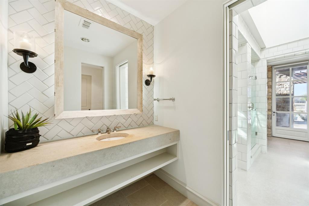 700 Jenkins Road Aledo, TX 76008 - Photo 29 of 40 a bathroom with a granite countertop sink and a mirror