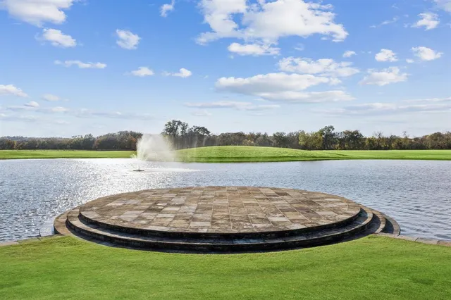 a view of a swimming pool with a yard and green space