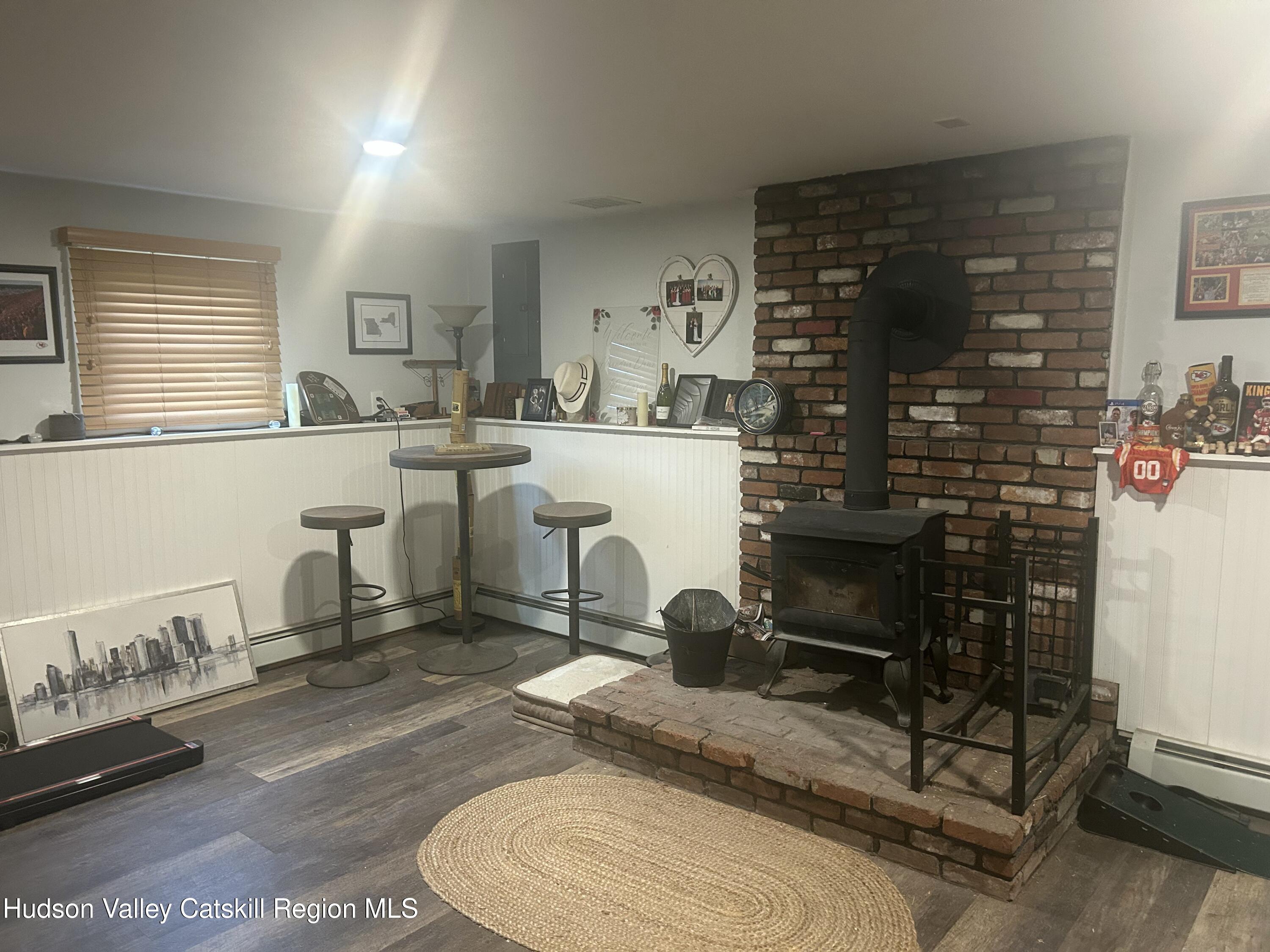 22 Caywood Road Poughkeepsie, NY 12603 - Photo 10 of 27 a room with a chair a table and a fireplace