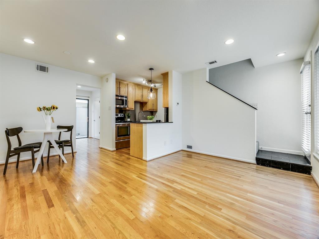 an empty room with wooden floor and furniture