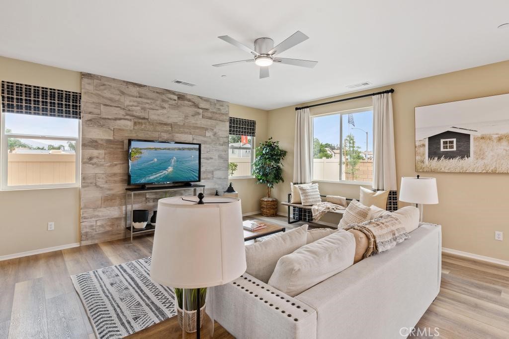 a living room with furniture a large window and a flat screen tv