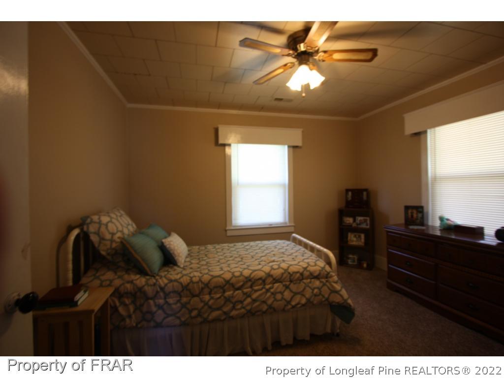 1063 Carl Freeman Road Stedman, NC 28391 - Photo 11 of 17 a bedroom with a bed and a chandelier