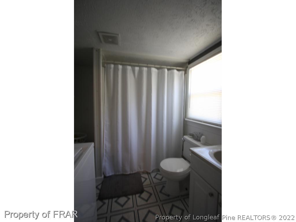 1063 Carl Freeman Road Stedman, NC 28391 - Photo 14 of 17 a bathroom with a toilet and a shower