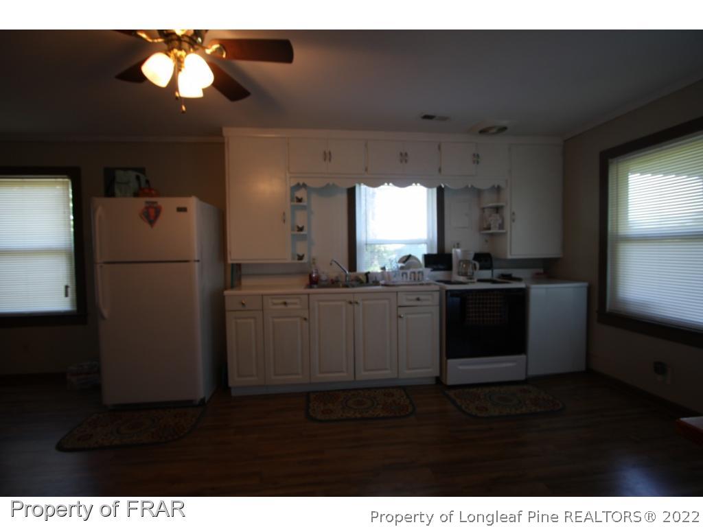 1063 Carl Freeman Road Stedman, NC 28391 - Photo 15 of 17 a kitchen with a refrigerator and windows