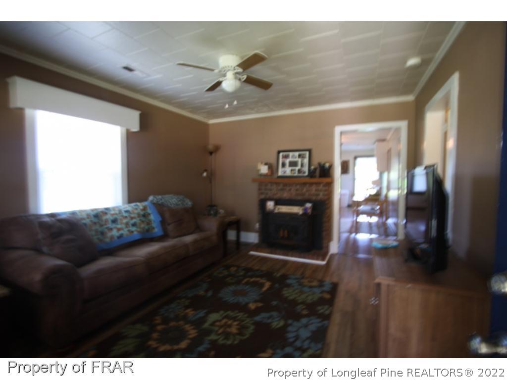 1063 Carl Freeman Road Stedman, NC 28391 - Photo 17 of 17 a living room with furniture and a fireplace