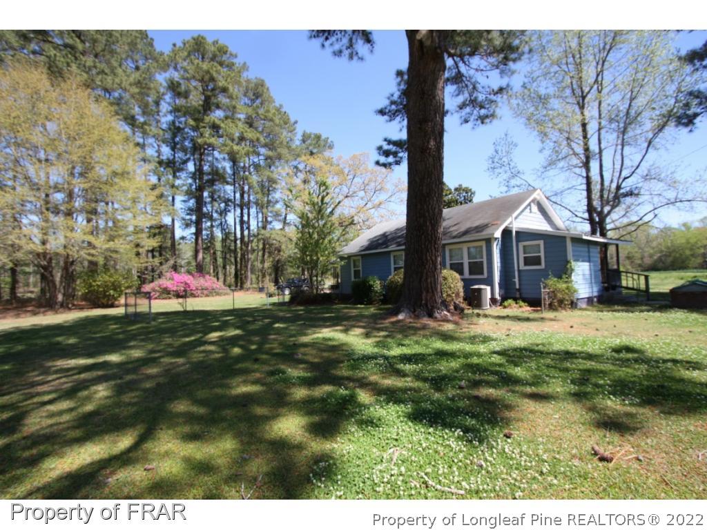 1063 Carl Freeman Road Stedman, NC 28391 - Photo 4 of 17 a front view of house with yard space and trees around