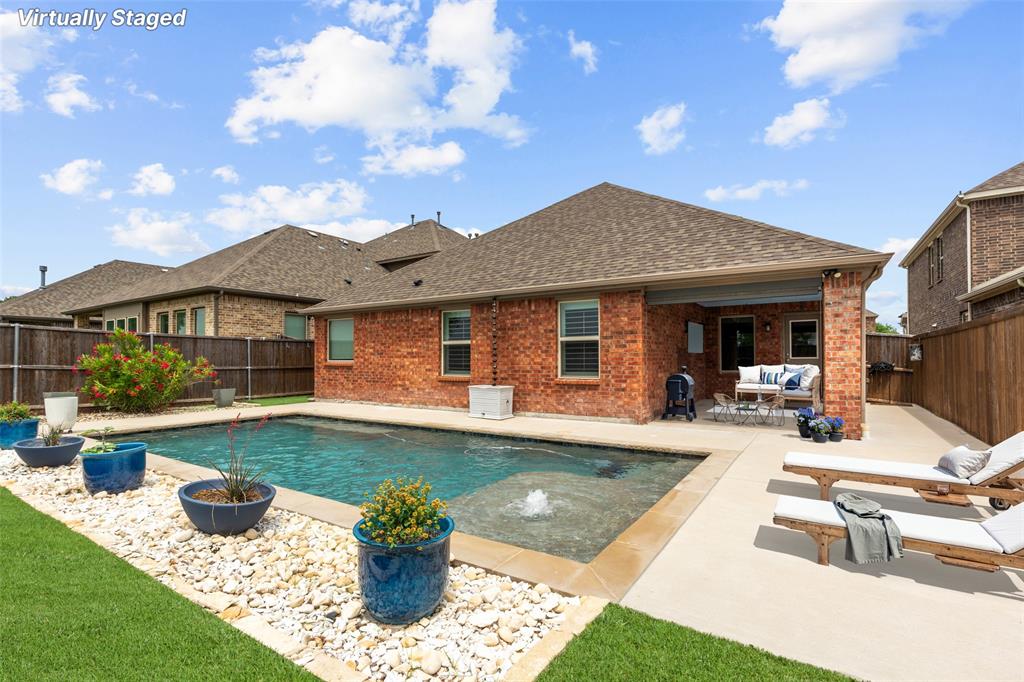 a view of a house with swimming pool and sitting area