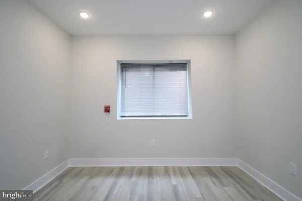 a view of a room with wooden floor and cabinet
