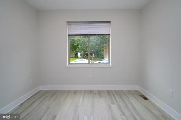 a view of a room with wooden floor and window