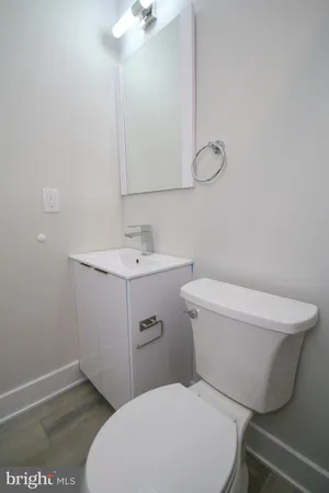 a white toilet sitting next to a bathroom sink