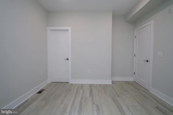 an empty room with wooden floor