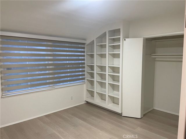 a view of an empty room with a fireplace and a window