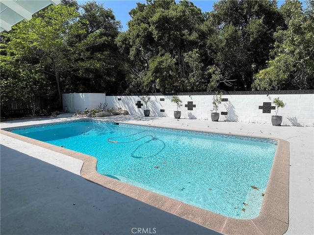 a terrace with a bench and trees