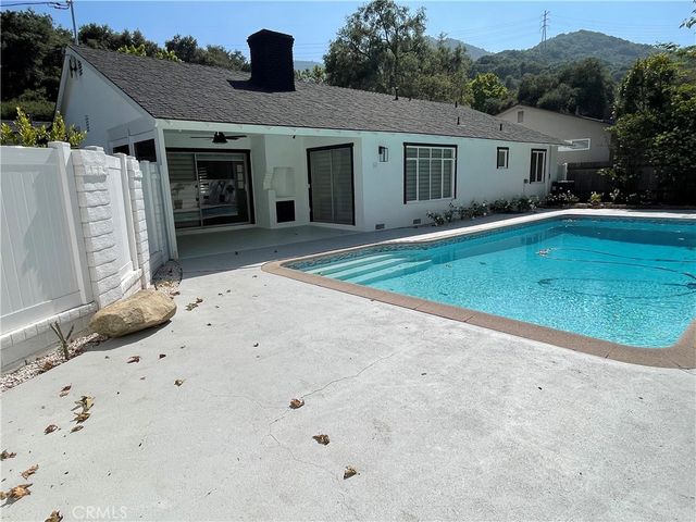 a view of an empty room with a fireplace and a window