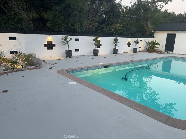 a view of an empty room with a fireplace and a window