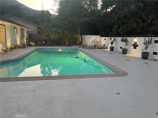 a view of a house with a yard and sitting area
