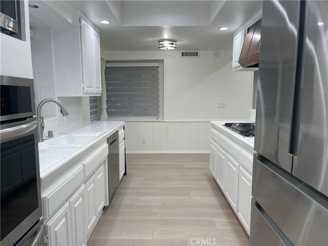 a kitchen with granite countertop a sink and cabinets