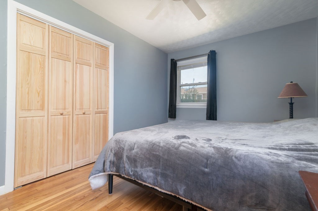 34 Clark Road Rockland, MA 02370 - Photo 13 of 37 a bedroom with a bed and wooden floor