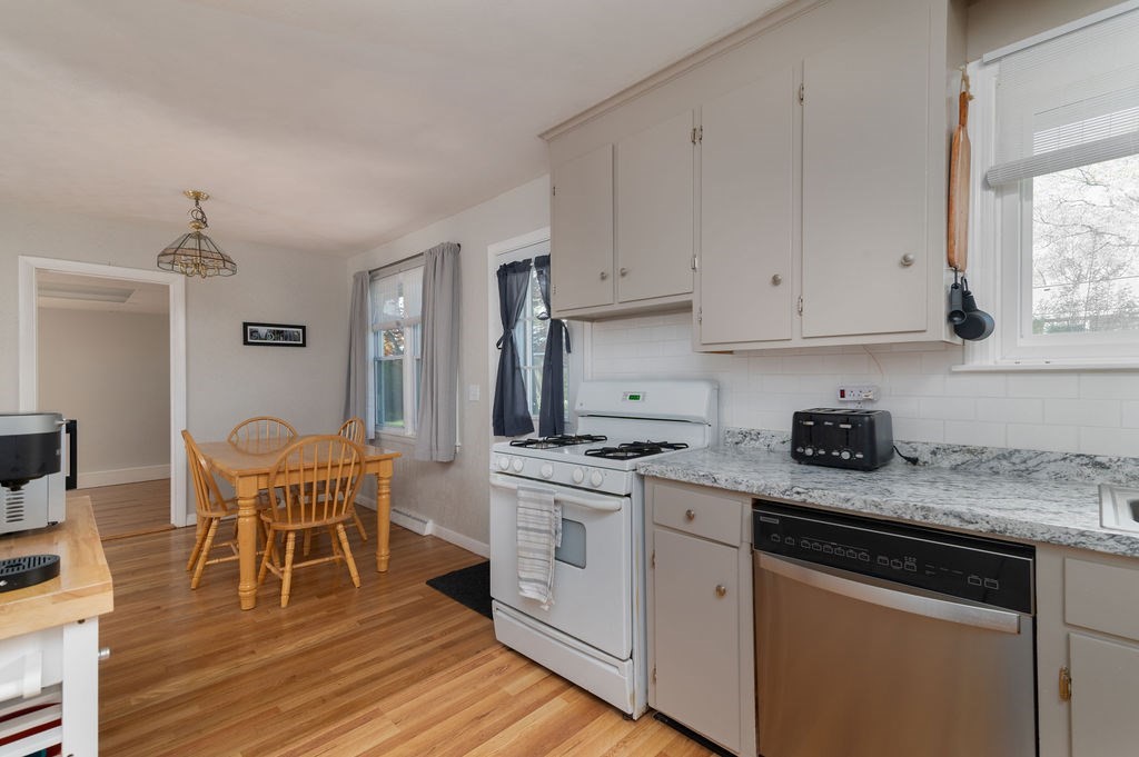 34 Clark Road Rockland, MA 02370 - Photo 8 of 37 a kitchen with stainless steel appliances granite countertop a white cabinets and wooden floor
