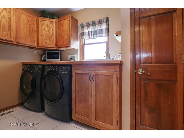 978 Plum Tree Road Fox River Grove, IL 60021 - Photo 12 of 25 a kitchen with stainless steel appliances granite countertop a refrigerator and a sink